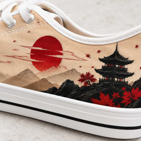 Red sun and mountain artwork on women’s sneakers