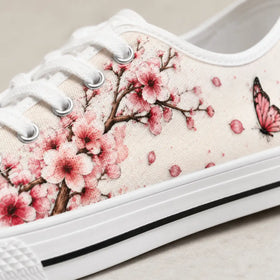 Soft pink floral artwork on women’s low top sneakers